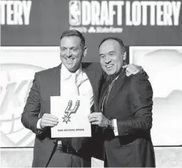  ?? NAM Y. HUH AP ?? Spurs managing partner Peter J. Holt (left) stands with NBA Deputy Commission­er Mark Tatum after Tatum announced that the Spurs had won draft lottery.