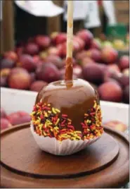  ?? PHOTO BY EMILY RYAN ?? Sprinkles add a festive touch to a Highland Orchards’ caramel apple.