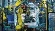  ?? CHRIS RATCLIFFE / BLOOMBERG ?? Robotic arms weld sections together on a Vauxhall Vivaro medium sized van in the bodyshop at the Vauxhall plant in Luton, United Kingdom.