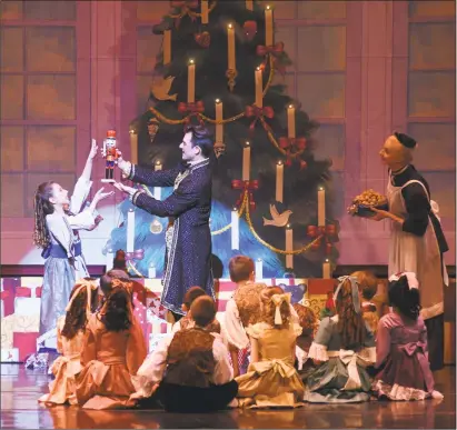  ?? Courtesy of Thomas Giroir Photograph / Contribute­d photos ?? Clara receives a nutcracker in the New Haven Ballet’s production of “The Nutcracker” at the Shubert Theater.