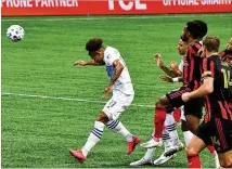  ?? HYOSUB SHIN / HYOSUB.SHIN@AJC.COM ?? Orlando City midfielder Junior Urso heads the ball to make a shot on goal during the first half in Atlanta United’s 3-1 loss Saturday at Mercedes-Benz Stadium.