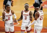  ?? Eric Gay / Associated Press ?? UT’S Courtney Ramey, center, celebrates with Matt Coleman III, left, and Kai Jones after the victory pushed the Horns to 9-1 (3-0 Big 12).