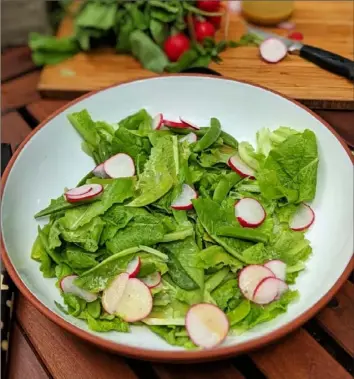  ?? Gretchen McKay/Post-Gazette ?? A simple salad of lettuce, radishes and sugar snap peas dressed in a tangy honey-mustard vinaigrett­e.