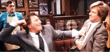  ?? ?? Punch-up: Mike swings for Ken Barlow (William Roache) at the Rovers Return in 1990