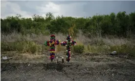  ?? Photograph: Eric Gay/AP ?? Crosses and candles mark the site where officials found dozens of people dead in a semitraile­r.