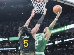  ?? USA TODAY SPORTS ?? The Celtics’ Jayson Tatum, right, shoots against the Warriors.