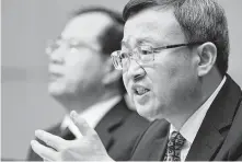  ?? Greg Baker / Getty Images ?? Chinese Vice Minister of Commerce Wang Shouwen appears at a news conference Tuesday, saying the tariffs are like “holding a knife to our neck.”