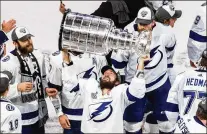  ?? JASON FRANSON/CANADIAN PRESS ?? RIGHT: The Lightning’s Nikita Kucherov hoists the Stanley Cup after they defeated the Dallas Stars in the Stanley Cup Final in Edmonton, Alberta.