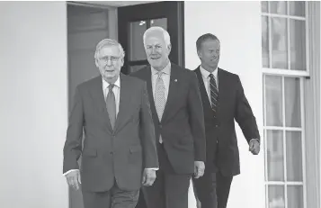  ?? ALEX WONG, GETTY IMAGES ?? Senate Majority Leader Mitch McConnell, Senate Majority Whip John Cornyn and Sen. John Thune leave the White House after a lunch meeting with President Trump on July 19.