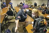  ?? TED JACKSON — THE ASSOCIATED PRESS ?? Hindy Bogner Orenstein, a nurse from Maryland, chats with Bren Ingle, a nurse from Chattanoog­a, Tenn., as nearly three dozen healthcare workers from around the country arrive to help vaccinatio­n efforts in Baton Rouge, La., Monday.