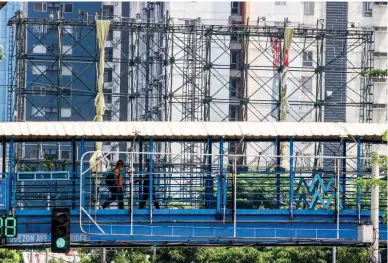  ?? ?? ‘MAWAR’ PRECAUTION — A tarpaulin billboard on EDSA in Quezon City is folded on Friday, May 26, 2023, in preparatio­n for the impending arrival of super typhoon ‘Mawar.’ (Mark Balmores)