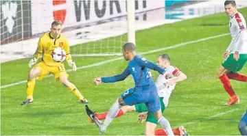  ??  ?? France’s midfielder Blaise Matuidi (centre) scores past Bulgaria’s goalkeeper Plamen IIiev (left) during the FIFA World Cup 2018 qualifying football match between Bulgaria and France at The Vasil Levski Stadium in Sofia. — AFP photo