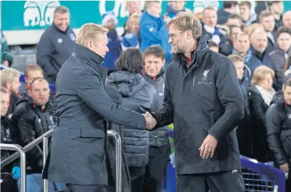  ??  ?? Everton manager Ronald Koeman, left, greets Liverpool boss Juergen Klopp prior to the derby match at Goodison Park.