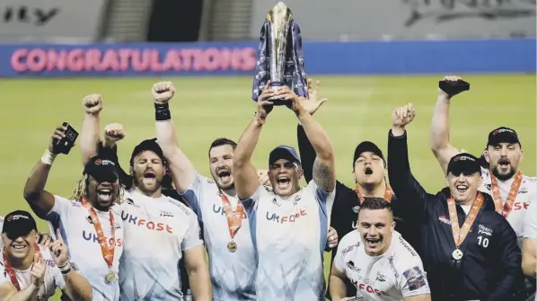  ??  ?? 0 Sale Sharks’ Jono Ross lifts the trophy as he celebrates with his team-mates after beating Harlequins in the Gallagher Premiershi­p Cup final at the AJ Bell Stadium.