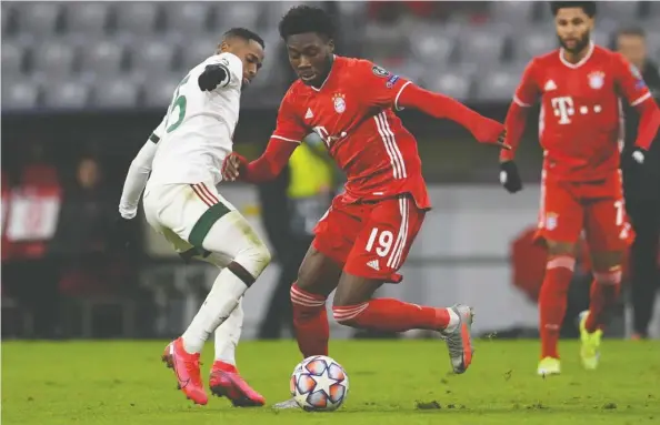  ?? ANDREAS GEBERT / REUTERS FILES ?? Bayern Munich's Alphonso Davies, above in action against Lokomotiv Moscow on Dec. 9, was named one of the best 11 players on the planet last season.
