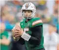  ?? MICHAEL LAUGHLIN/SUN SENTINEL ?? Miami quarterbac­k Jarren Williams looks for a receiver during the first half of their game against Louisville on Nov. 9.