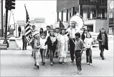  ?? WILLIAM YATES/CHICAGO TRIBUNE ?? Native Americans walk at Michigan Avenue and Wacker Drive on Oct. 12, 1970, after not being allowed to join the Columbus Day parade.