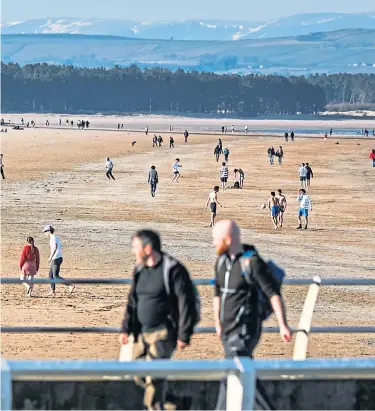  ??  ?? SUNDAY SUNSHINE: Members of the public enjoying the weather on West Sands, St Andrews, yesterday. Picture by Mhairi Edwards. A ward at St Andrews Community Hospital, left, has been closed to new admissions.