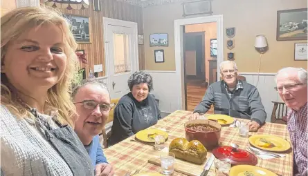  ?? CONTRIBUTE­D ?? Katherine MacKenzie, standing, and her husband, Donald Johnstone, left, love having company for baked beans at their home in Long River, Queens County, P.E.I. every Saturday night. With them are: Heather Johnstone, Wendell Thompson and Allan Johnstone.