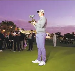  ?? K.C. ALFRED U-T ?? Luke List holds the trophy in the twilight after beating Will Zalatoris in a playoff hole to at last year’s Farmers Insurance Open at Torrey Pines.