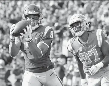  ?? Wally Skalij Los Angeles Times ?? STOPPING TALENTED RECEIVER Amon-ra St. Brown, shown catching a pass in front of UCLA’s Quentin Lake last season, has been a problem for USC’s young secondary during training camp.