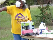  ??  ?? Lafayette School Restoratio­n Group member Flossie Moore organizes cleaning material purchased with the ABHOF grant shortly before cleaning the Lafayette Gym. (Contribute­d)