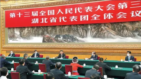  ?? HUANG JINGWEN / XINHUA ?? President Xi Jinping participat­es in a discussion with National People’s Congress deputies from Hubei province on Sunday in Beijing.