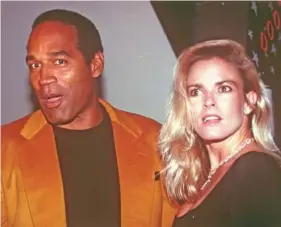  ?? AP PHOTO/PAUL HURSCHMANN ?? O.J. Simpson, left, and his wife, Nicole Brown Simpson, arrive in 1993 for the opening of the Harley-Davidson Cafe in New York.