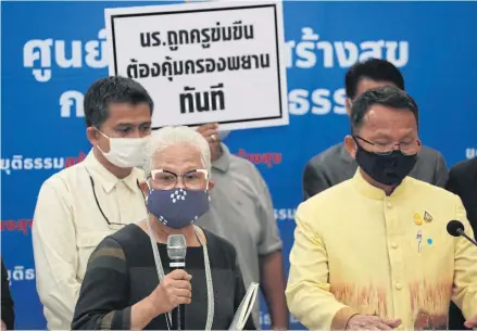  ?? VARUTH HIRUNYATHE­B ?? Rights activists led by child protection advocate Thicha Na Nakhon, left, hold placards denouncing the gang rape of schoolgirl­s by teachers and alumni in Mukdahan province.