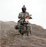  ??  ?? Photo shows Clickenger riding her motorcycle in India, descending the mountains headed for Manali.