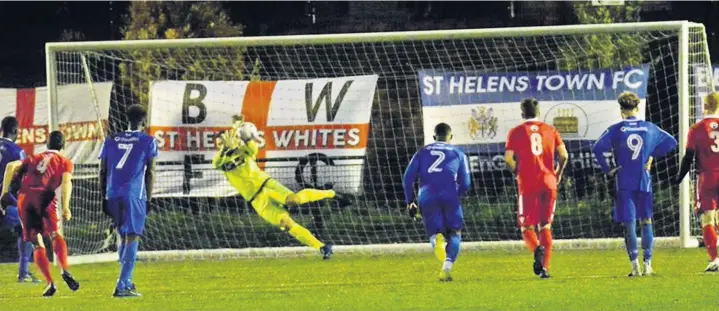  ?? John Driscoll ?? Skem keeper Ben Barnes saves Moses Yoak’s penalty for St Helens Town