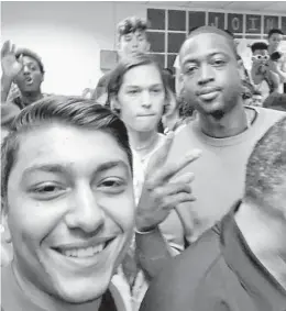  ?? JOEY PELOSE VIA TWITTER/COURTESY ?? Miami Heat star Dwyane Wade paid a surprise visit to Marjory Stoneman Douglas High School in Parkland and at least one overjoyed student declared on social media that it was the “Greatest moment of my life.” Wade dedicated the remainder of this season to Joaquin Oliver, one of the 17 victims killed in the Feb. 14, 2018, mass shooting.