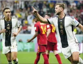  ?? LUCA BRUNO — THE ASSOCIATED PRESS ?? Germany’s Niclas Fuellkrug, right, celebrates after he scored his side’s first goal which tied Sunday’s World Cup group E match against Spain. The match ended in a 1-1draw.