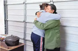  ?? MARLA BROSE/JOURNAL ?? Monty Singer, a Diné man from Albuquerqu­e travelling to North Dakota to protest the Dakota Access Pipeline, right, gets a hug from fellow artist Denali Brooke after she donated a Dutch oven and a case of beans for the group.