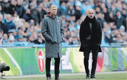  ?? FRANK AUGSTEIN THE ASSOCIATED PRESS ?? Arsenal manager Arsene Wenger, left, and Manchester City coach Pep Guardiola stand next to each other during the English League Cup final match at Wembley stadium in London, Sunday.