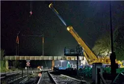  ?? STORY CONTRACTIN­G / CHRIS BAINES ?? The footbridge over the main line is about to be lifted early on February 13, with the smaller section on the right over the SVR next. The centre pillar has since been demolished.