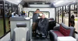  ?? RECORDER PHOTO BY CHIEKO HARA ?? Jesse Medina shaves Keith Froeschle inside of Medina's Mobile Barber vehicle Wednesday in Portervill­e. Medina has been traveling home to home to provide the service twice a week in the Portervill­e area for about 5 months now.