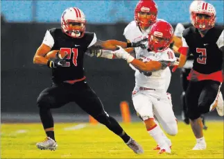  ?? JOSH HOLMBERG/ LAS VEGAS REVIEW-JOURNAL ?? Liberty receiver Darion Acohido, left, fends off Arbor View safety Phenix Calinao in the first half of the Patriots’ 27-23 home victory Friday. Acohido had four receptions for 117 yards.