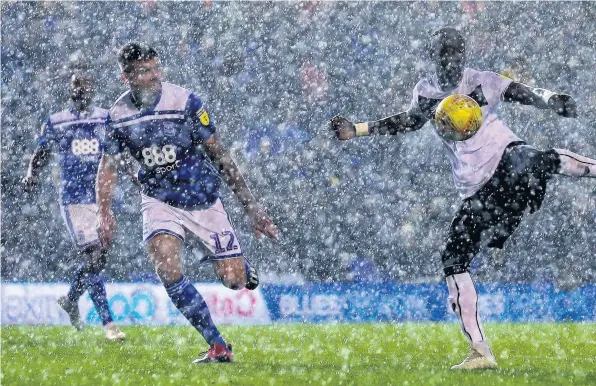  ??  ?? Bristol City’s goalscorer Famara Diedhiou shoots at goal as heavy rain falls at Birmingham City’s St Andrew’s Ground