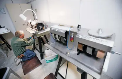  ??  ?? ABOVE: Jim Hill, the lapidary teacher at Meltdown Studio, sets up the equipment last week in the lapidary studio at Meltdown Studio’s new Santa Fe location, 3209 Mercantile Court off Rufina Street.