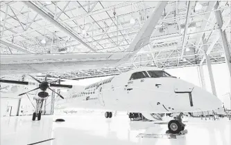  ?? AARON VINCENT ELKAIM
THE CANADIAN PRESS ?? A Bombardier Q400 jet sits in a hangar at the Bombardier facility in Toronto. The company said it will sell its Q400 turboprop aircraft program to a subsidiary of Longview Aviation Capital Corp.