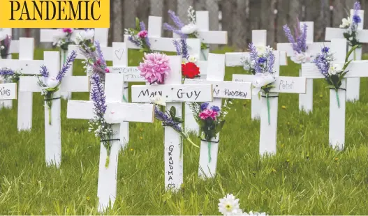  ?? PETER J THOMPSON / POSTMEDIA NEWS ?? Crosses stand outside the Camilla Care Community long-term care facility in Mississaug­a, Ont., near Toronto, where 50 people have died of COVID-19 as of this week.