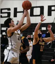  ?? DREW ELLIS — MEDIANEWS GROUP ?? Madison Heights Bishop Foley’s Adam Kidder (23) puts up a shot over the defense of Royal Oak Shrine’s Aaron Smith (11) during Wednesday’s 63-46victory.