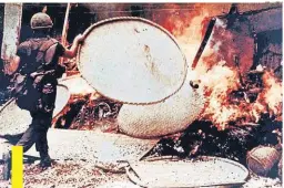  ??  ?? A soldier burns a dwelling in this photo from the 1970 Report of Army review into the My Lai incident.