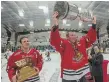  ?? THE HAMILTON SPECTATOR ?? Ryan Christie hoists the Allan Cup in 2014 when the Dundas Real McCoys won the championsh­ip at home. The Canadian senior hockey championsh­ip returns to Dundas next month after a three-year pandemic layoff.
