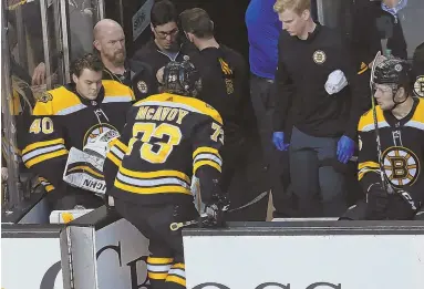  ?? STAFF PHOTO BY JOHN WILCOX ?? UNWELCOME SIGHT: Bruins defenseman Charlie McAvoy (73) leaves the ice with a lower-body injury early in last night’s win against the Canadiens at the Garden. He did not return.