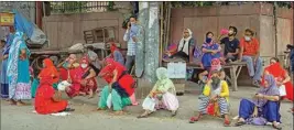  ?? PTI ?? Women wait outside a fair price shop to collect free ration, in East Delhi, Wednesday