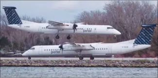  ?? The Canadian Press ?? A Porter Airlines plane lands next to a taxiing plane at Toronto’s Billy Bishop Airport. Aimia and the Porter regional airline plan to form new Aeroplan partnershi­p after Aimia’s current deal with Air Canada ends in 2020.