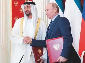  ??  ?? Shaikh Mohammad and Putin after signing the partnershi­p agreement at the Kremlin. WAM