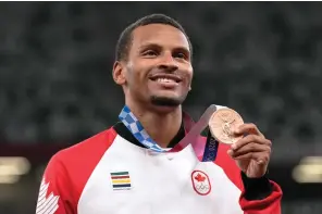  ?? The Canadian Press ?? Andre De Grasse, of Canada, poses with his bronze medal following the men’s 100-meter final at the 2020 Summer Olympics, Monday, in Tokyo.